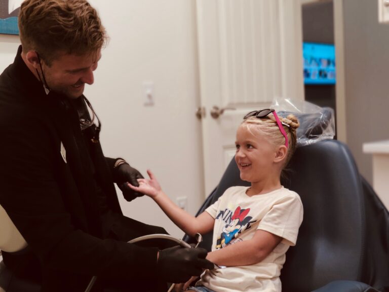 Dr. Austin Williams talking with a young patient
