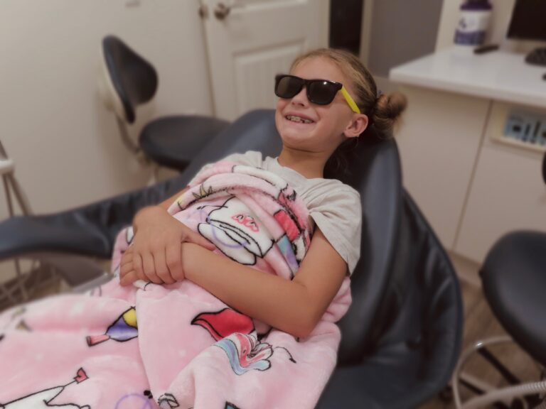 Smiling patient relaxing in sunglasses during a visit